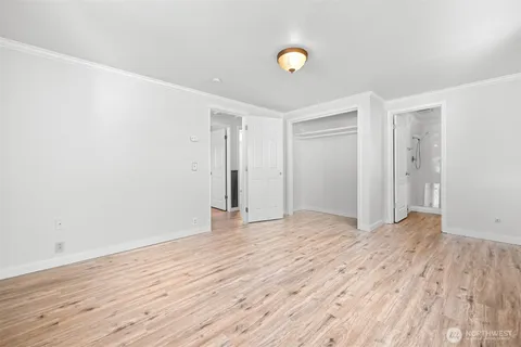 a view of an empty room and wooden floor