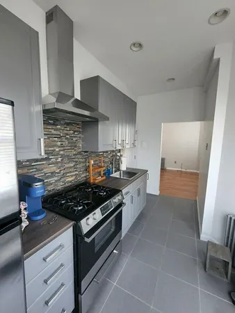 a kitchen with stainless steel appliances a stove and cabinets