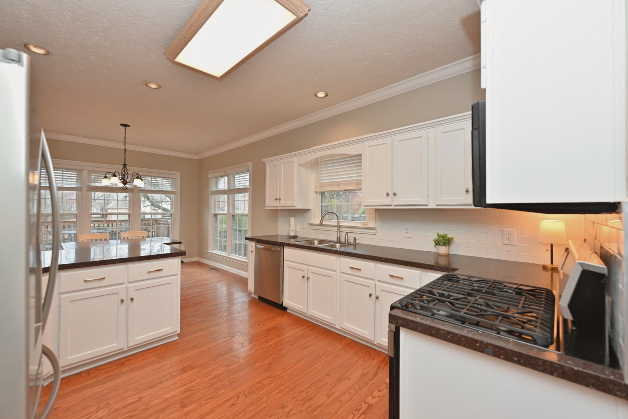 114 Wyncrest Way Hendersonville, TN 37075 - Photo 18 of 40 a kitchen with granite countertop white cabinets and white appliances