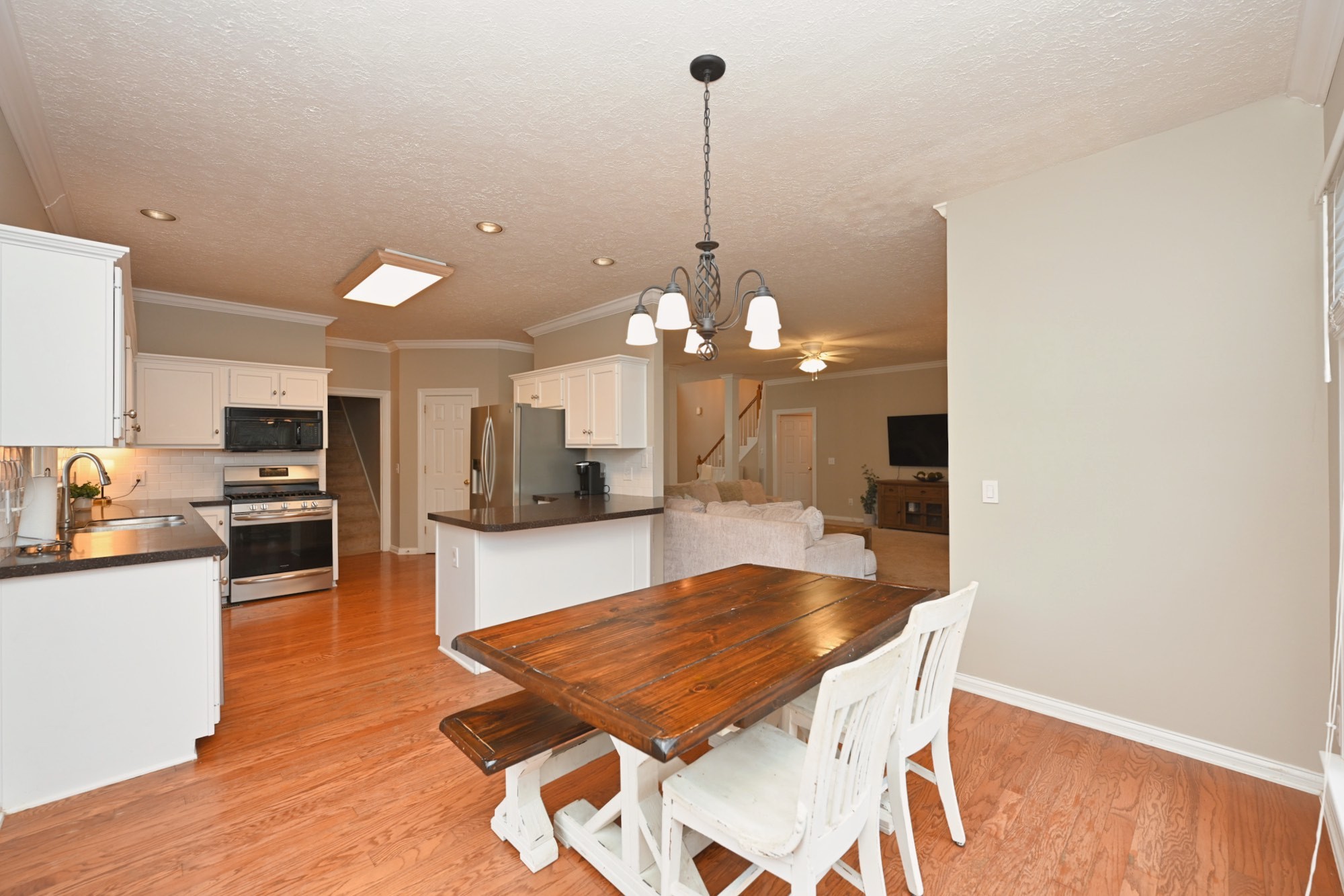 114 Wyncrest Way Hendersonville, TN 37075 - Photo 19 of 40 a dining room with furniture a chandelier and kitchen view