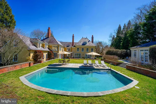a view of a swimming pool with a lounge chairs
