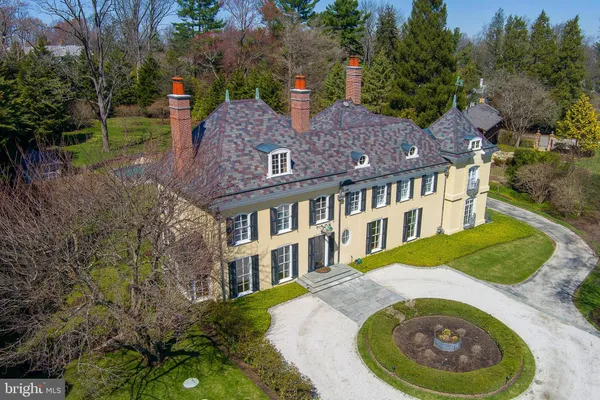 aerial view of a house with a garden and trees