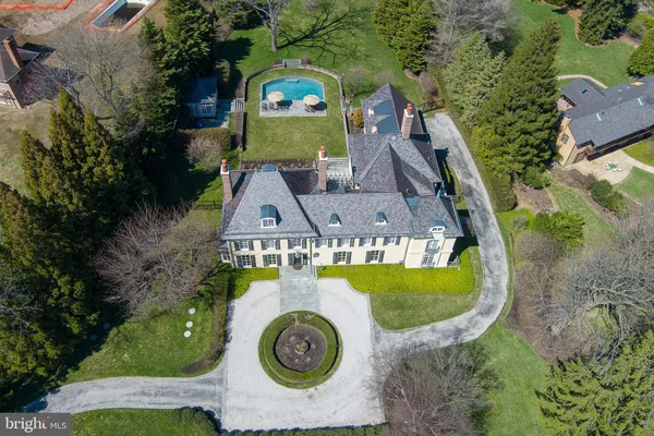 an aerial view of a house with a swimming pool outdoor seating yard and mountain view