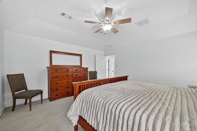 a bedroom with a bed and a dresser