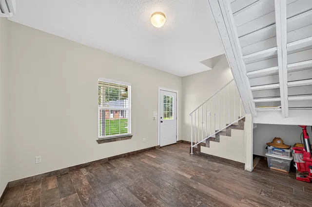a view of entryway and hall with wooden floor