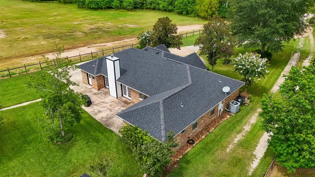 an aerial view of residential houses with outdoor space and swimming pool