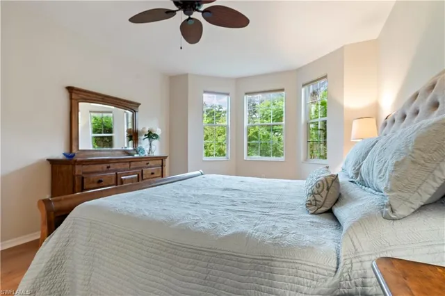 a bedroom with a large bed and a large window