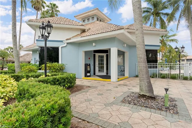 a swimming pool with outdoor seating and a palm tree