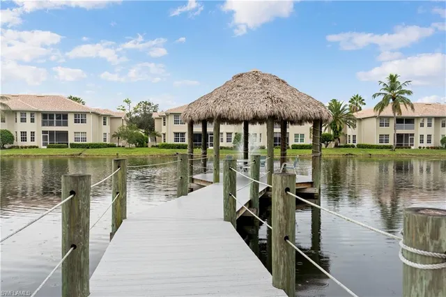a view of a patio with a table and chairs under an umbrella