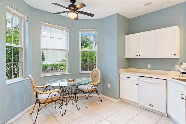 a kitchen with a dining table chairs and a window
