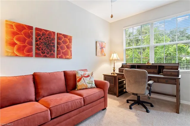 a view of livingroom with workspace and a window