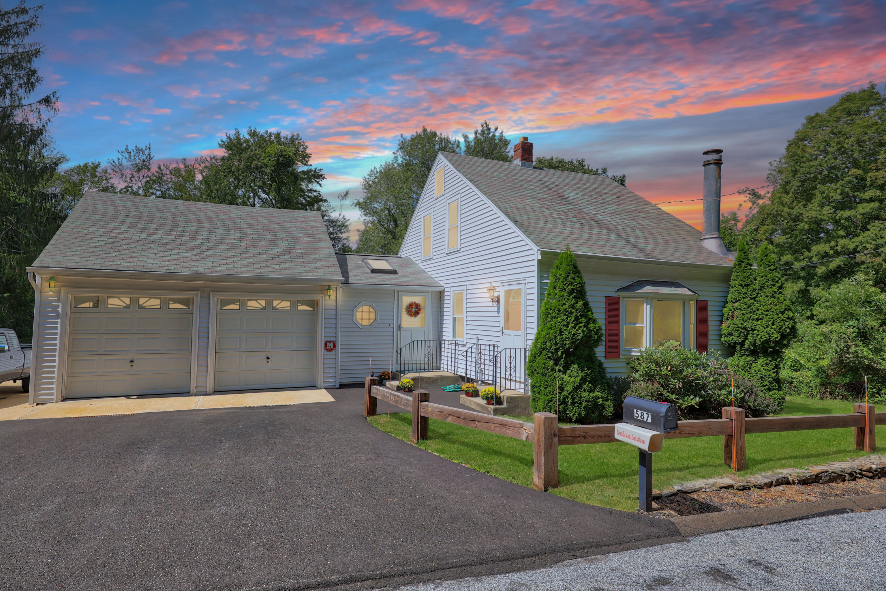 a front view of a house with a yard and garage