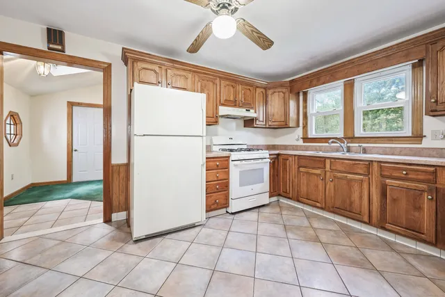a kitchen with a stove sink and refrigerator