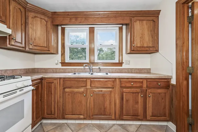 a kitchen with stainless steel appliances granite countertop a sink and a stove