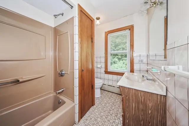 a bathroom with a sink a mirror and a bathtub