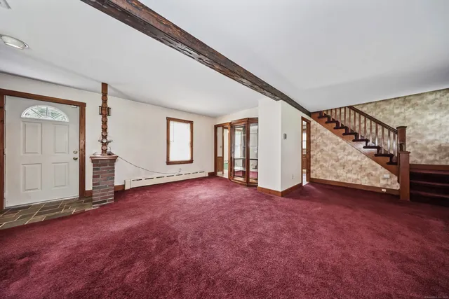 an empty room with windows and entryway