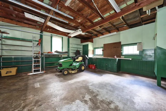 a view of a green yard with large trees
