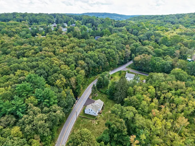 an aerial view of a house with a yard