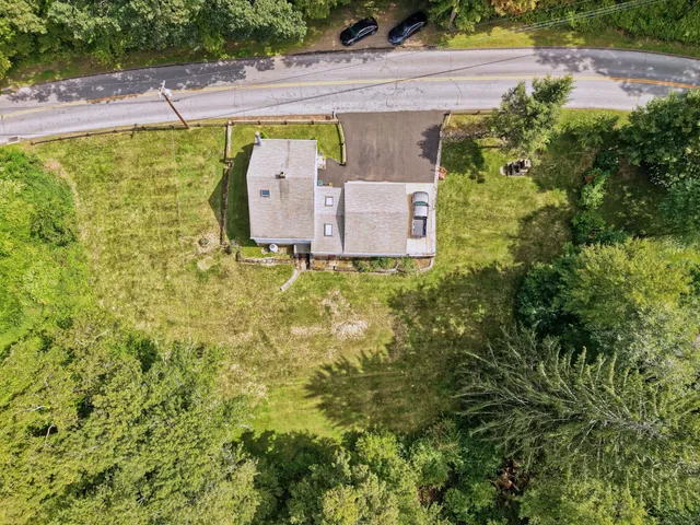 a view of backyard of house with green space
