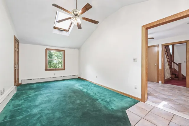 an empty room with fan and windows