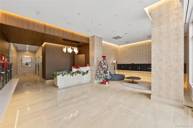 a view of a hallway with a couch and chandelier