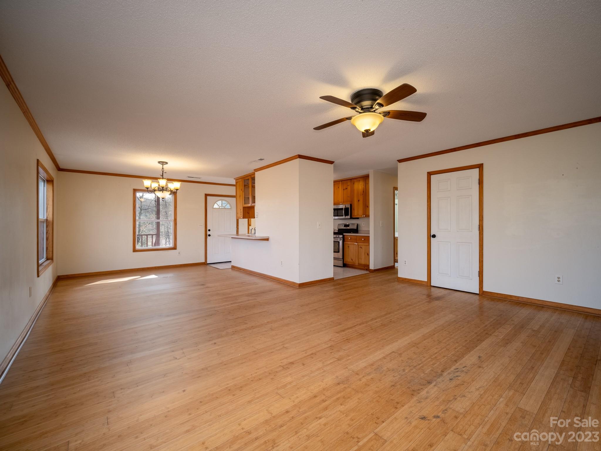430 Jeep Road Brevard, NC 28712 - Photo 16 of 45 a view of a room with a ceiling fan window and wooden floor