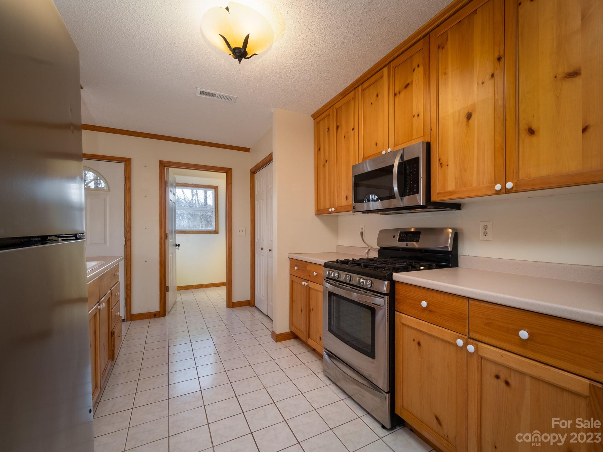 430 Jeep Road Brevard, NC 28712 - Photo 20 of 45 a kitchen with stainless steel appliances granite countertop a stove a sink and a refrigerator