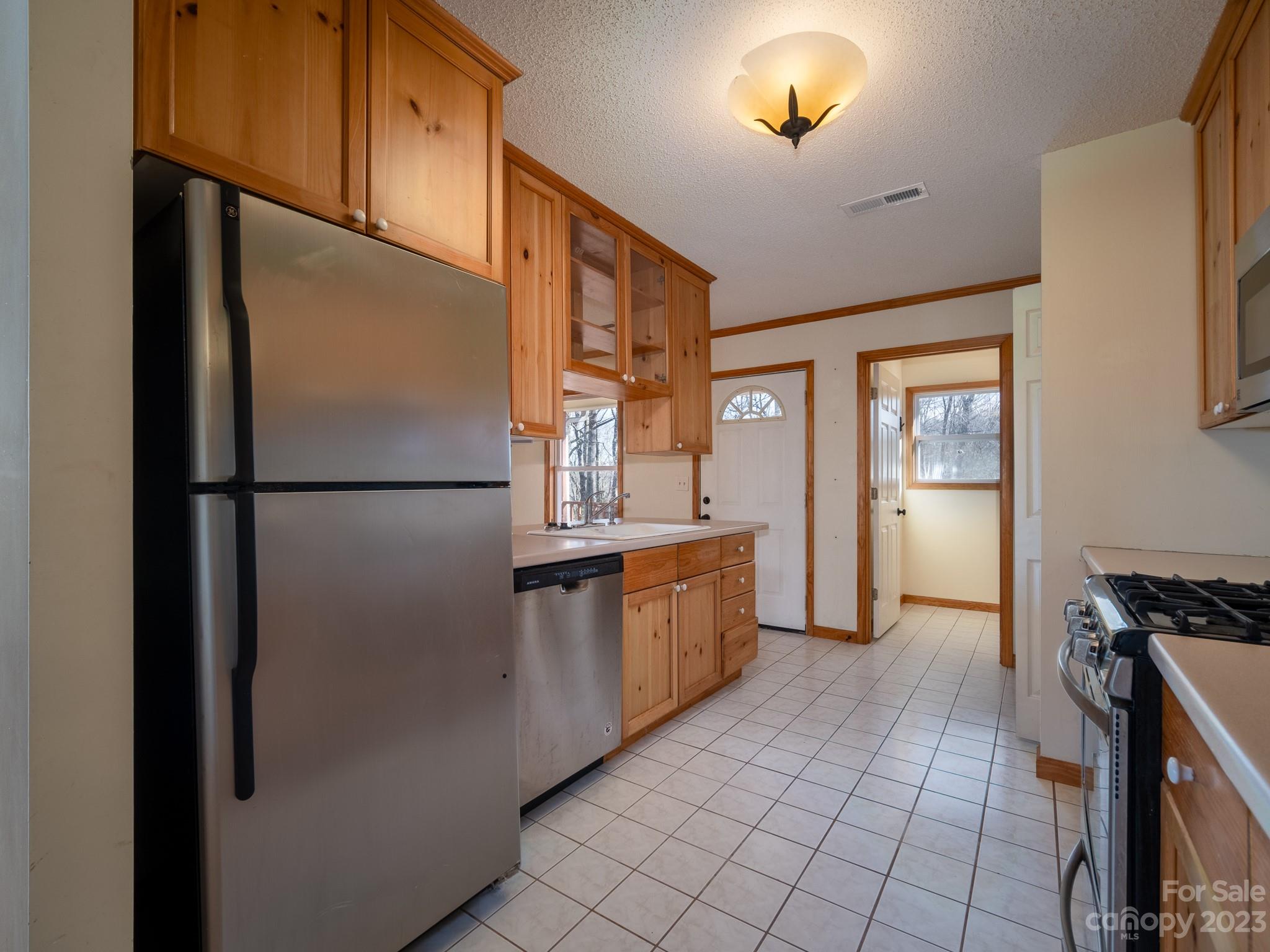 430 Jeep Road Brevard, NC 28712 - Photo 21 of 45 a kitchen with stainless steel appliances granite countertop a refrigerator and a sink