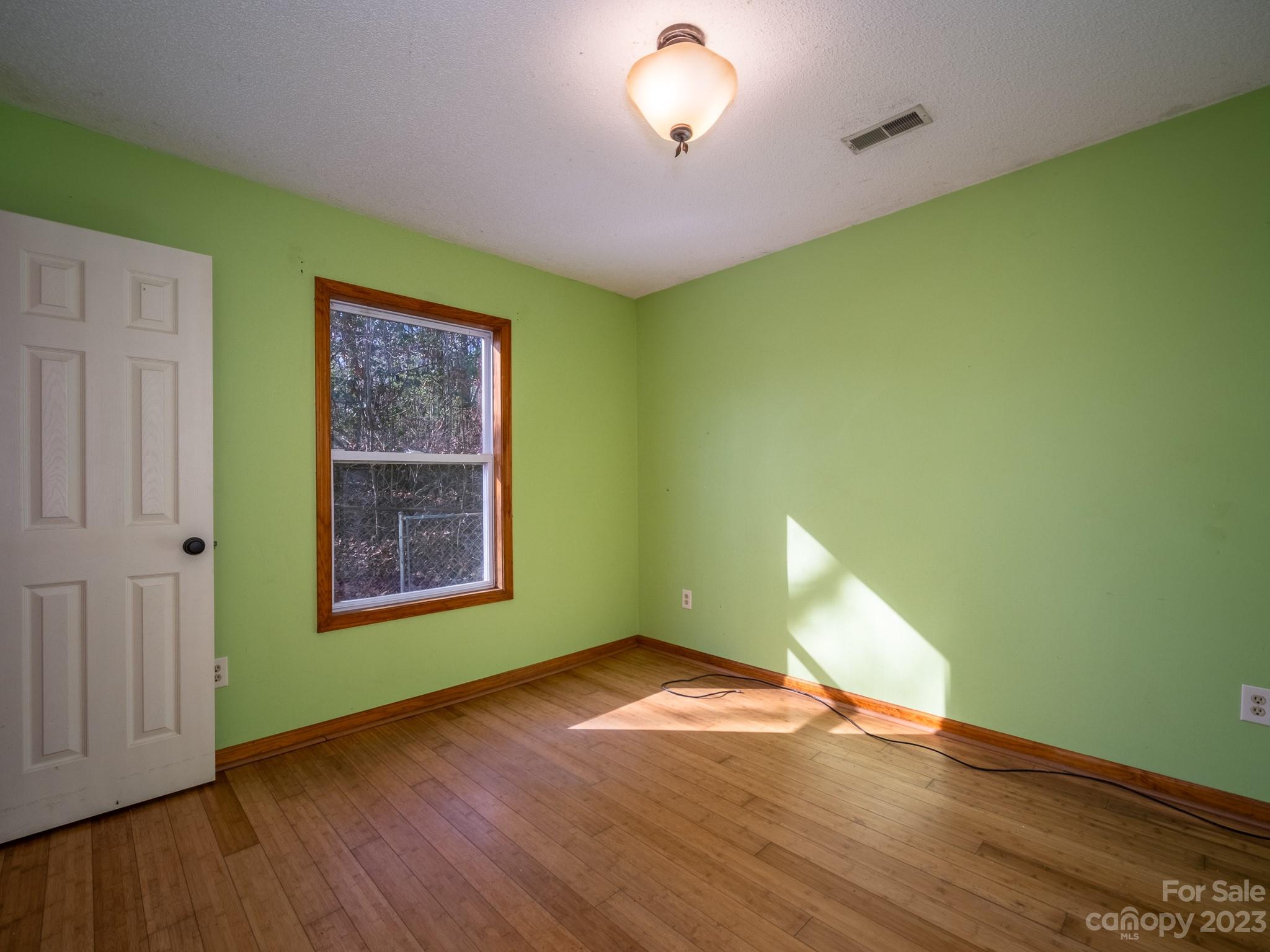430 Jeep Road Brevard, NC 28712 - Photo 34 of 45 an empty room with wooden floor and windows