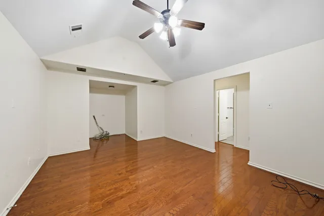 a view of empty room with ceiling fan