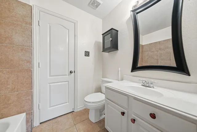 a bathroom with a sink a toilet and mirror