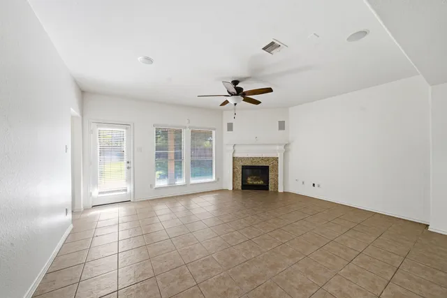 a view of an empty room with a fireplace