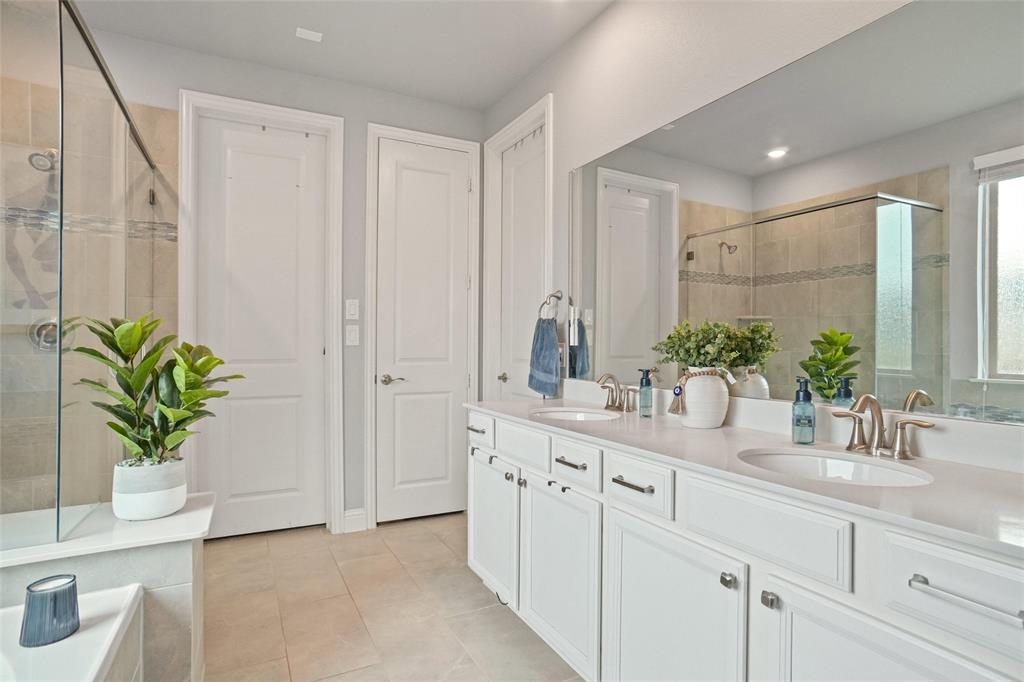 2202 Stanhill Drive Corinth, TX 76210 - Photo 16 of 29 a bathroom with a sink a vanity and a mirror
