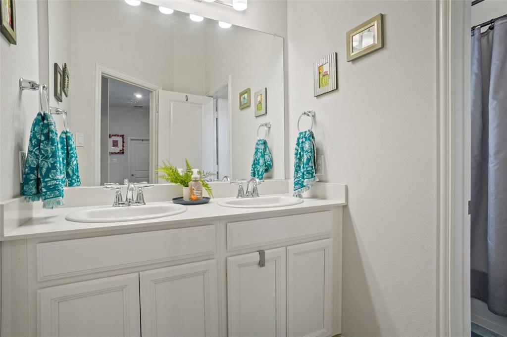 2202 Stanhill Drive Corinth, TX 76210 - Photo 24 of 29 a bathroom with a sink and a mirror