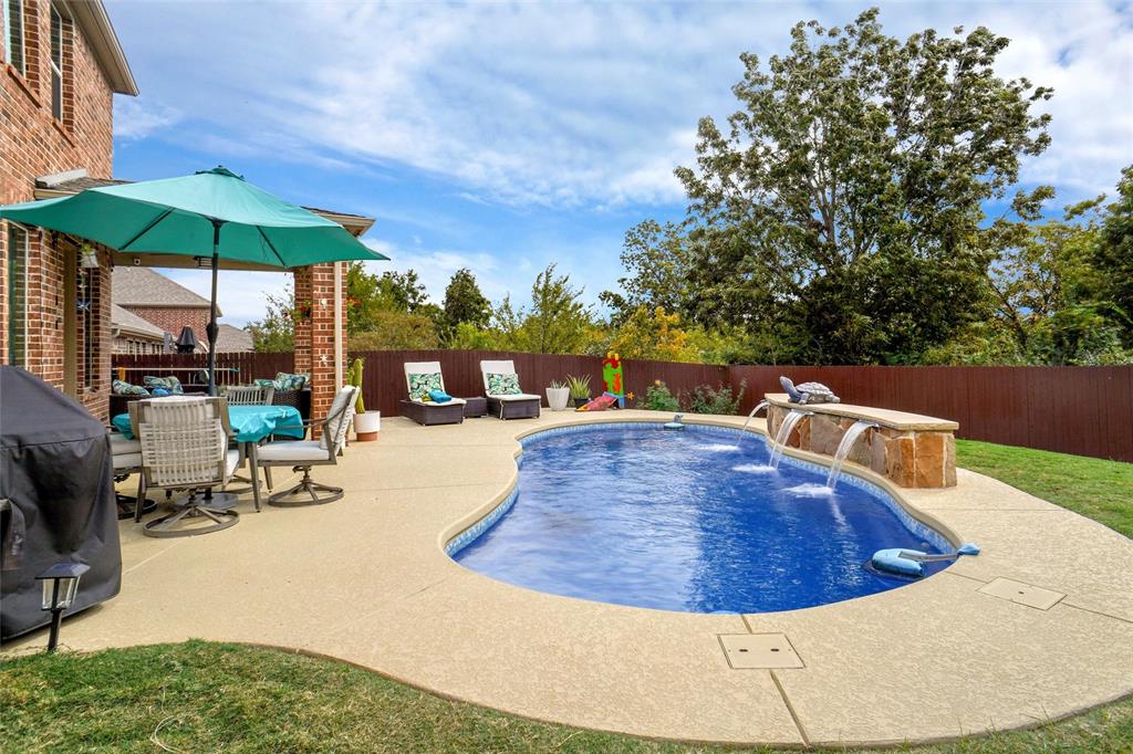 2202 Stanhill Drive Corinth, TX 76210 - Photo 26 of 29 a view of a swimming pool with a patio