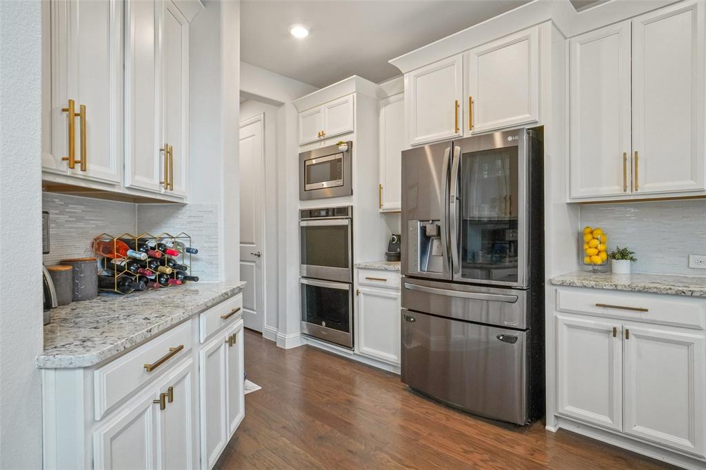2202 Stanhill Drive Corinth, TX 76210 - Photo 9 of 29 a kitchen with stainless steel appliances granite countertop a refrigerator and a stove