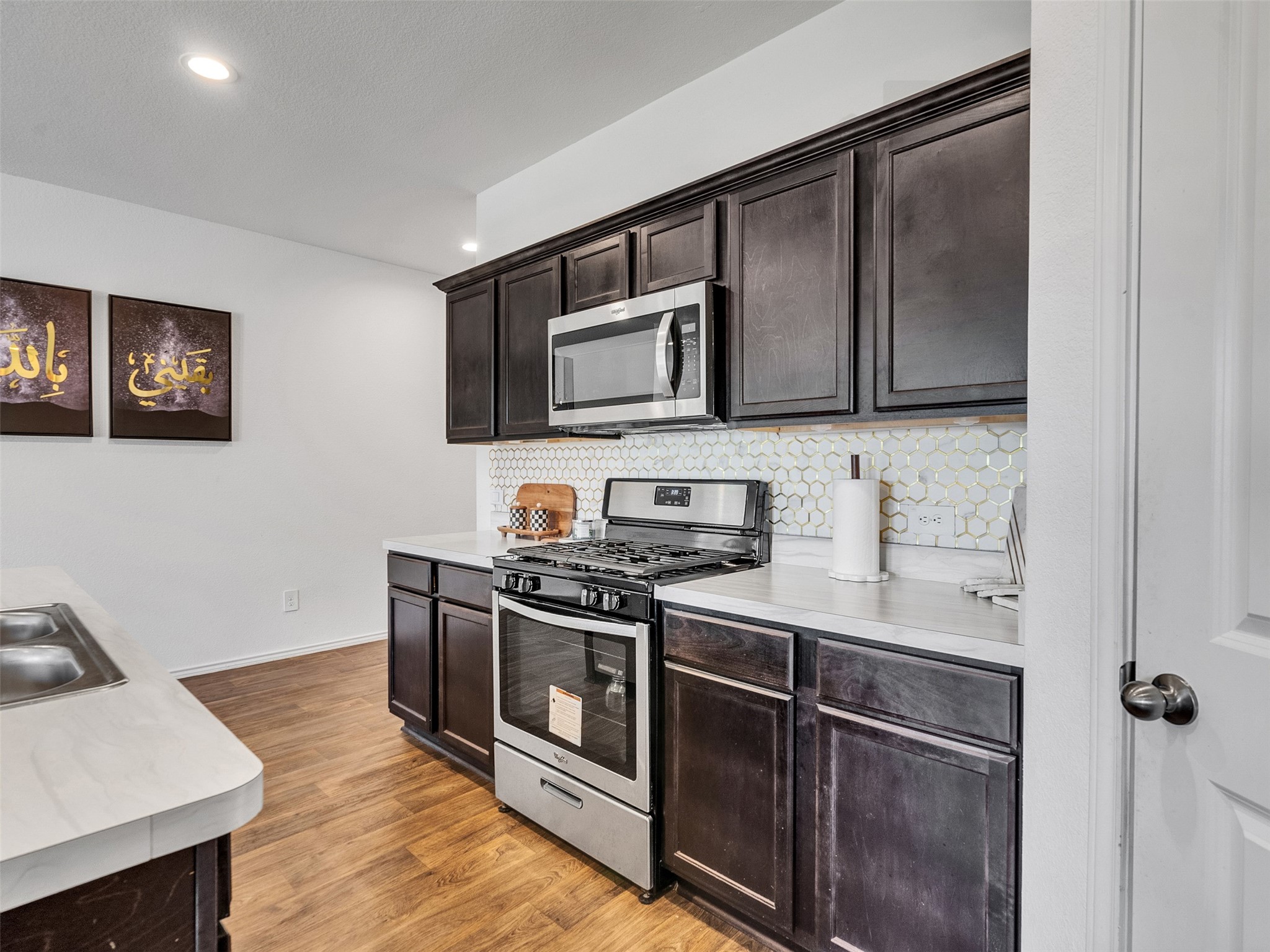 21215 Audubon Russet Road Katy, TX 77449 - Photo 15 of 30 a kitchen with stainless steel appliances granite countertop a stove a sink and a microwave