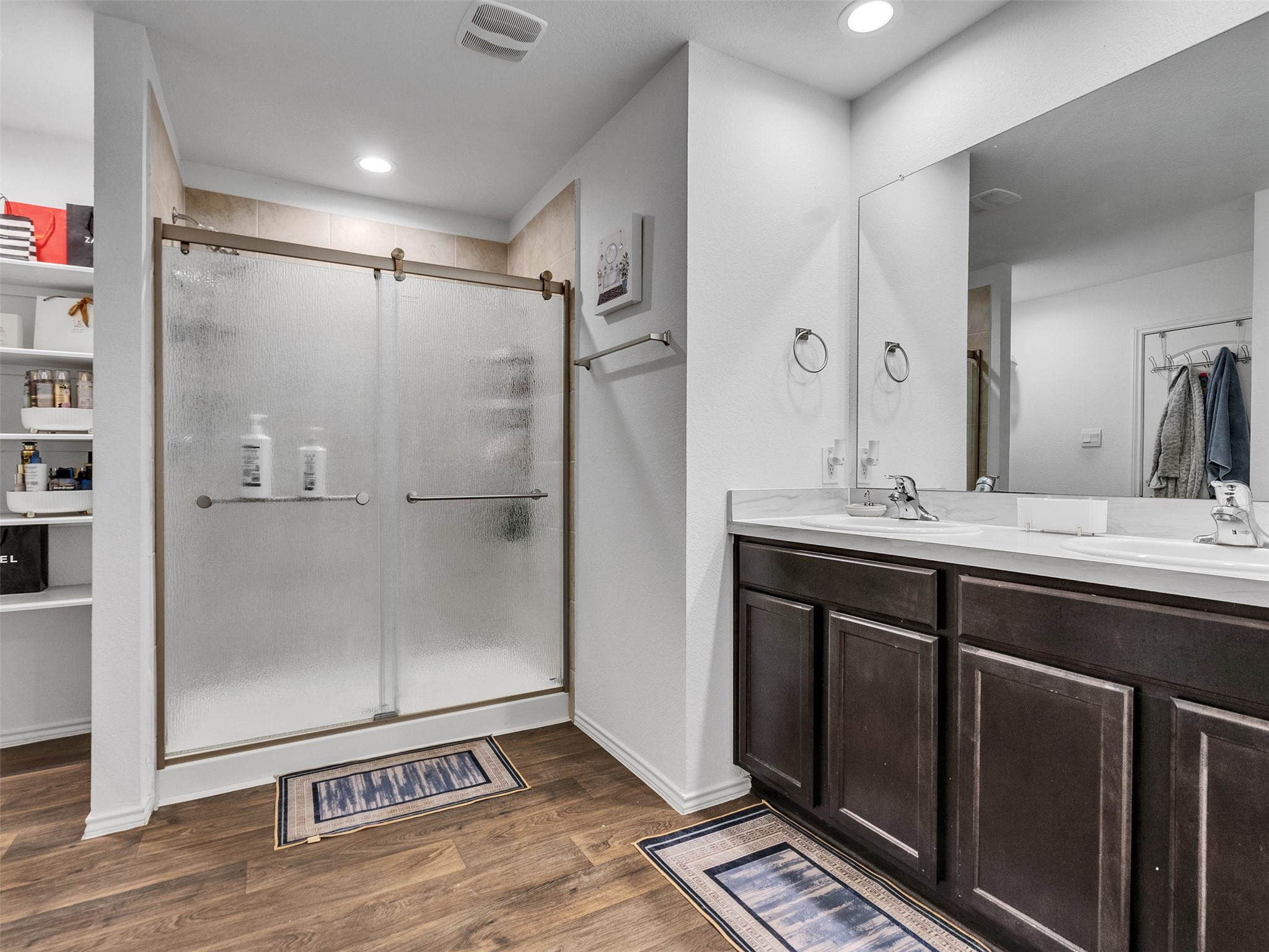21215 Audubon Russet Road Katy, TX 77449 - Photo 27 of 30 a bathroom with a shower sink and mirror
