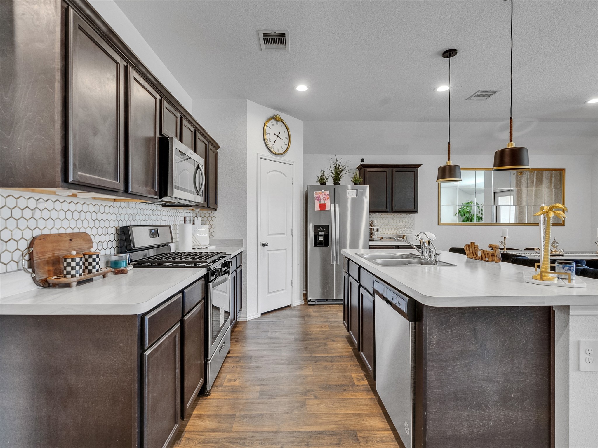 21215 Audubon Russet Road Katy, TX 77449 - Photo 10 of 30 a kitchen with stainless steel appliances granite countertop a sink stove and refrigerator