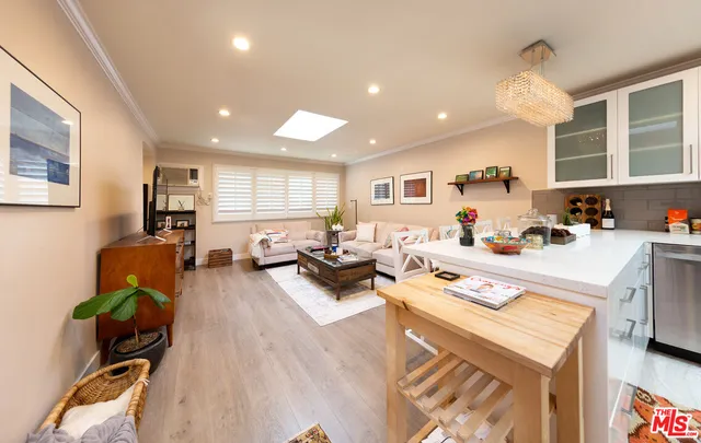 a kitchen with a sink stainless steel appliances and white cabinets