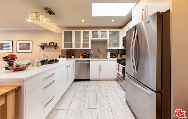 a kitchen with white cabinets and a sink