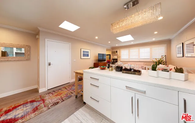 a spacious bedroom with a bed and a chandelier