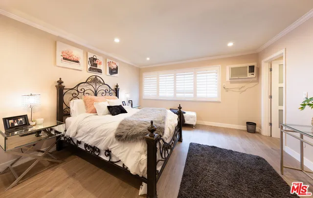 a bedroom with a large bed and a tv