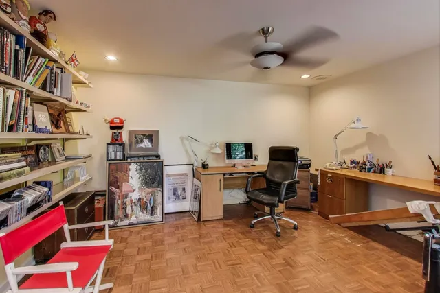 a bedroom with a bed and ceiling fan