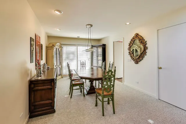 a living room with furniture a flat screen tv and a book shelf