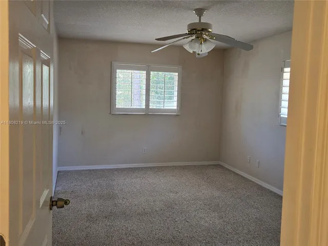 a view of a kitchen with a sink and chandelier