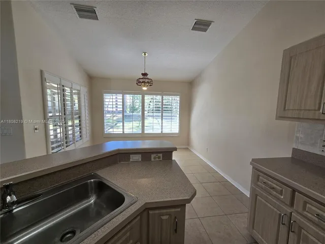 a bathroom with a granite countertop toilet and a sink