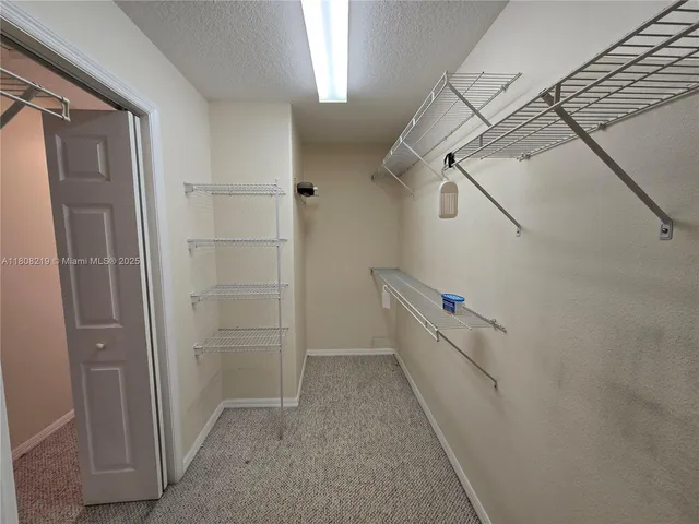 a bathroom with a granite countertop sink mirror and a bathtub