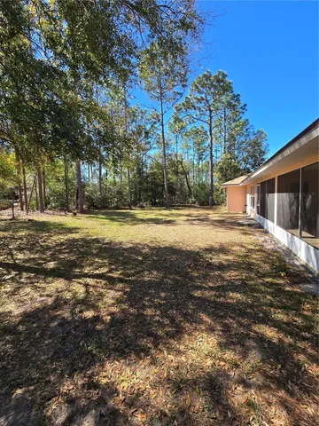 a view of a house with a yard and swimming pool