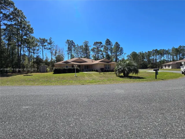 a bathroom with a granite countertop sink mirror and bathtub